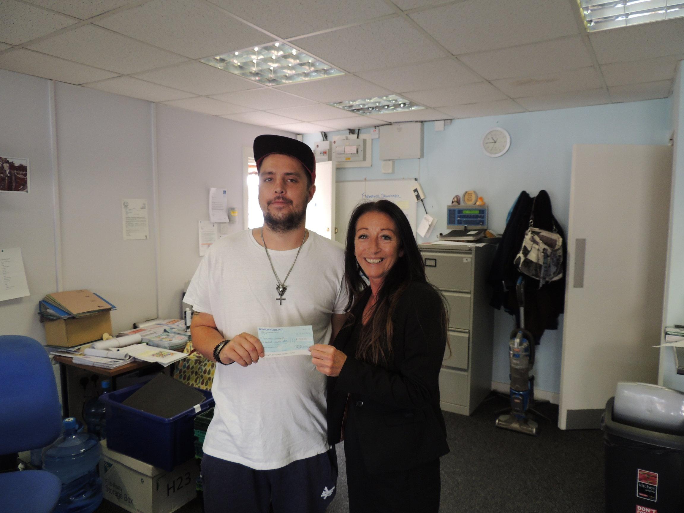 Asset Management Officer Lorraine Logan presents donation cheque to Drumchapel Food Bank